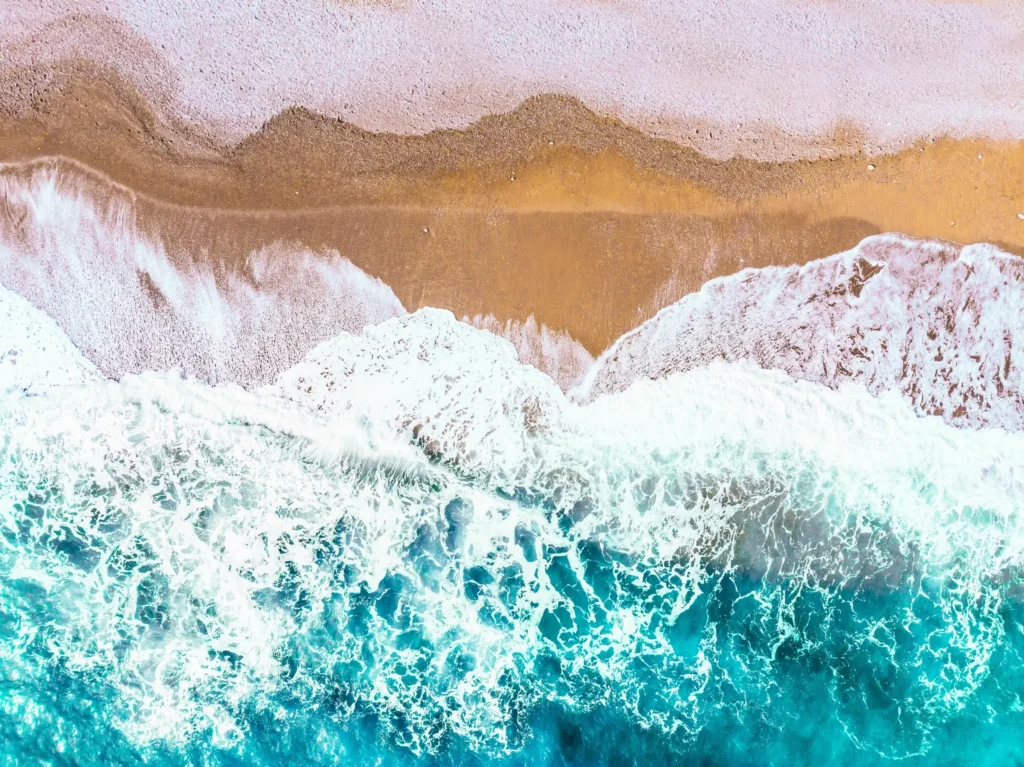 Waves on the sand, used as the header image for the psychedelic preparation and integration page for Michael Conti