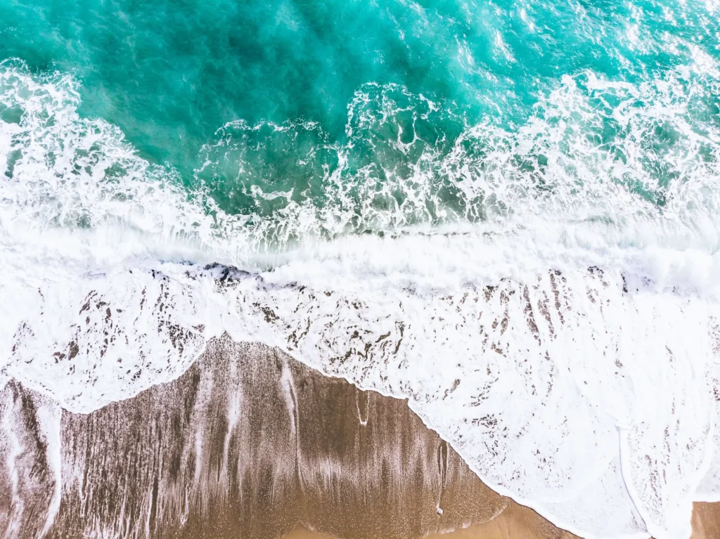Waves washing on the beach, used as the header image for the sexuality and gender therapy page for Michael Conti