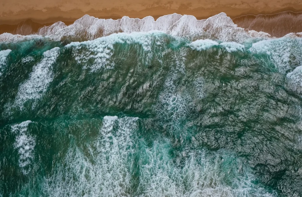 Waves crashing on the sand - header image for resources page of Michael Conti